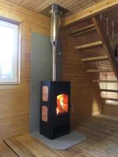 Популярный камин с дровницей Сибирь 8 в интерьере фото в Молодечно