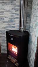 Стальной недорогой камин Теплодар ОВ-120 (угловой) фото в интерьере в Молодечно